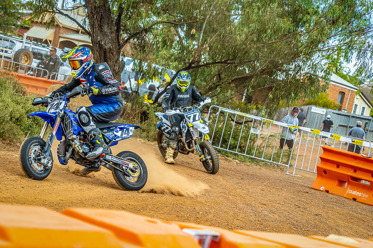 Couple of super motard bikes skidding and throwing dust