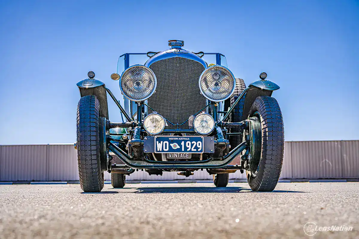 Low‑angle automotive photography of Bentley 1929 on cobblestone