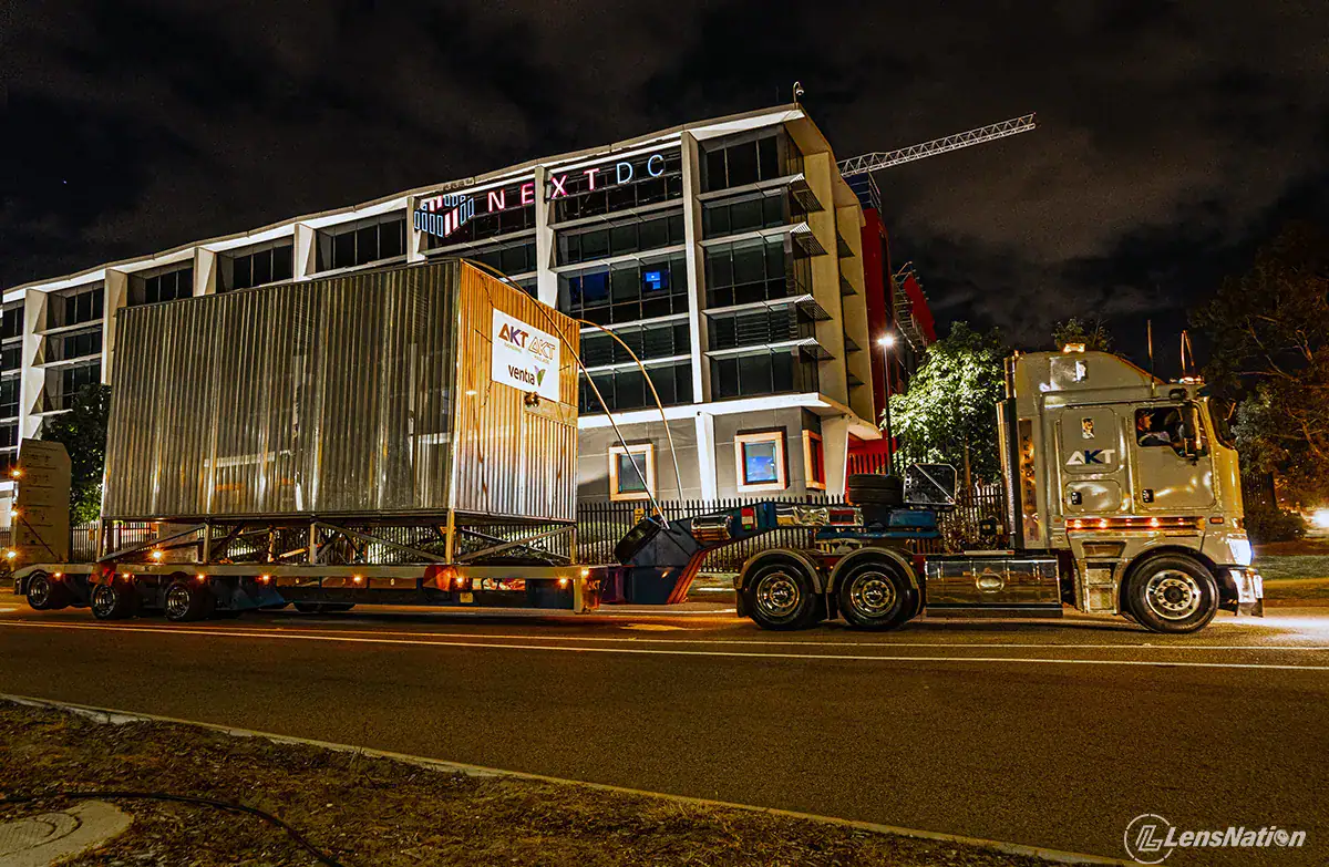 Perth-based industrial photography capturing heavy haulage transport in pre-dawn conditions, highlighting mining logistics and long-haul operations.