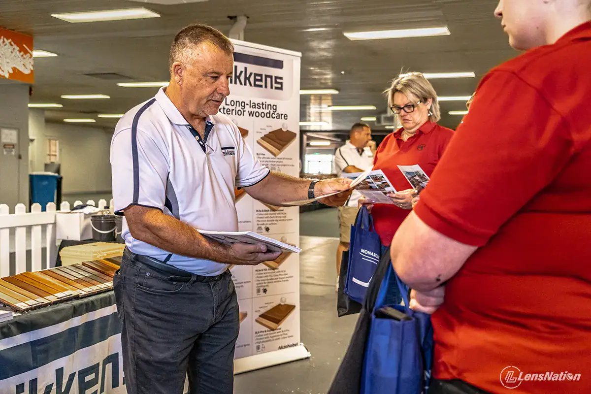 Expert demonstrating Sikkens paint layering technique to audience