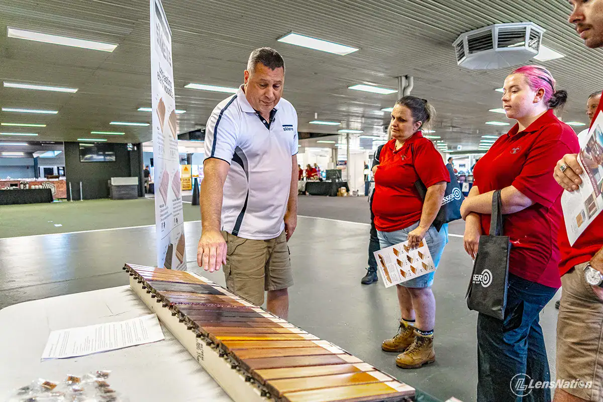 Expert demonstrating Sikkens paint layering technique to audience