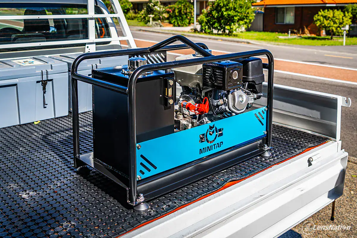 Detailed close-up of hot tapping machine cutting into water main