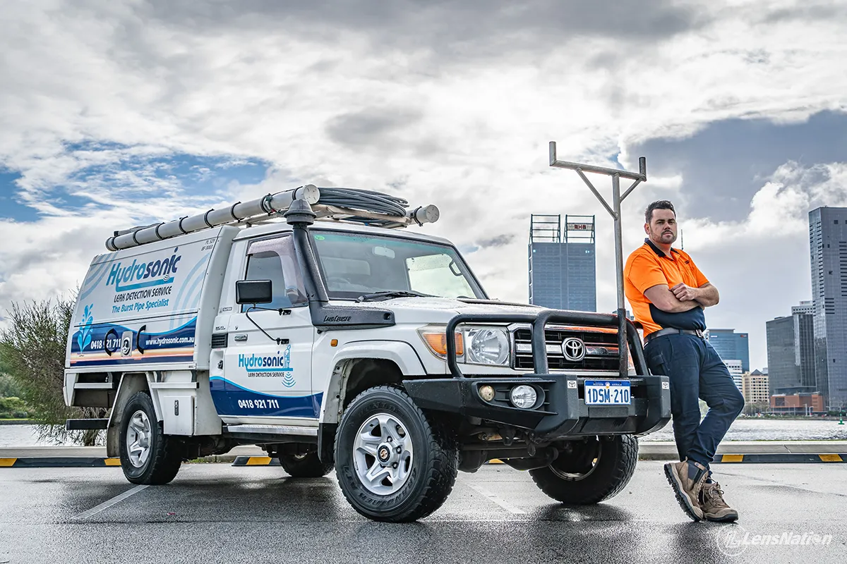 Plumbing service vehicle captured in natural light with Perth skyline behind in South Perth