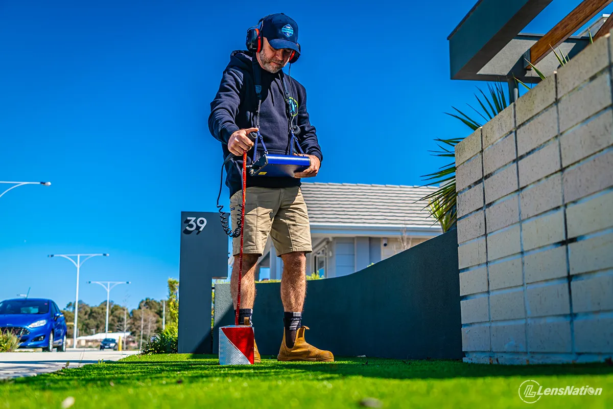 Small business photography Plumber looking for water leaks in front garden
