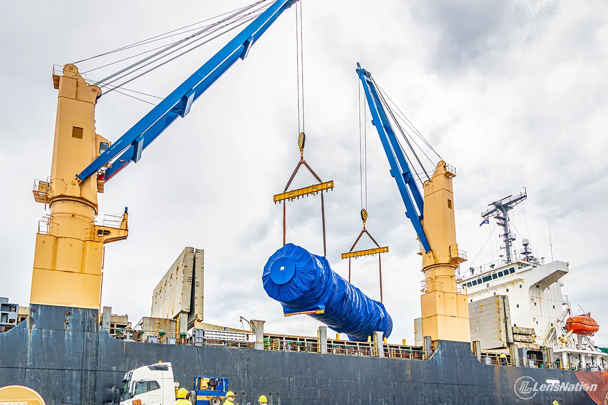 Industrial cargo unloading operation with mining equipment at Australian Marine Complex in Henderson