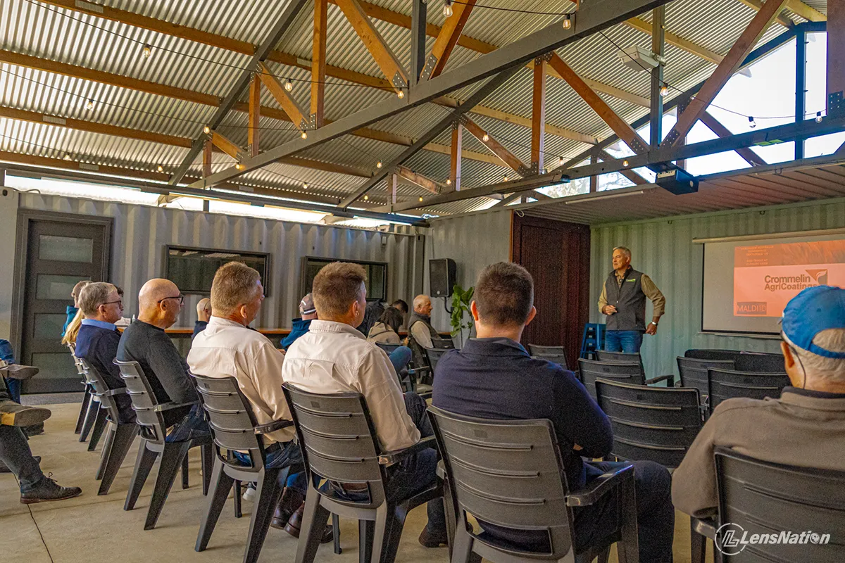 Photograph of main speaker at the event showcasing the attendees paying attention and listening to the address. 
